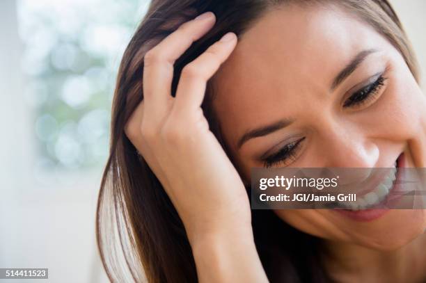 woman running fingers through her hair - 髪に手をやる　女性 ストックフォトと画像