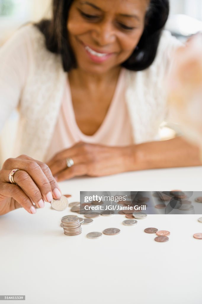 Mixed race woman counting change