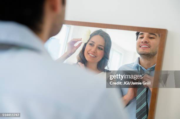 couple dressing in front of mirror - changed for the better stock-fotos und bilder