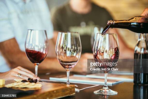 people drinking wine together in bar - winetasting stock pictures, royalty-free photos & images
