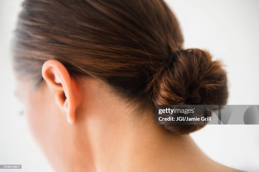 Close up of woman wearing bun in hair