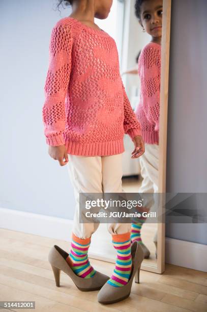 african american girl dressing up in mother's shoes - child high heels stock pictures, royalty-free photos & images