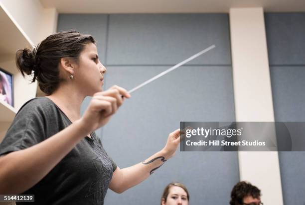 student conducting in music class - dirigent stock-fotos und bilder