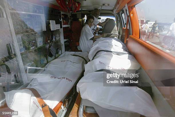 The bodies of victims taken from the scene of three bomb blasts at Egyptian holiday resorts are brought by ambulance across the border into Israel on...