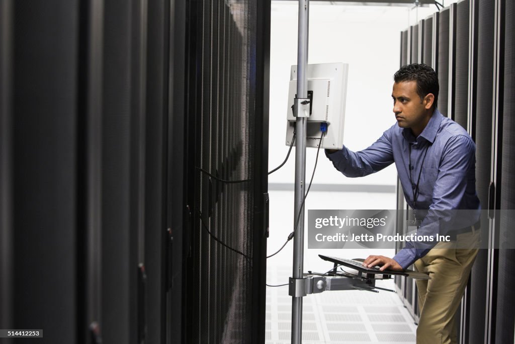 Indian businessman working in server room
