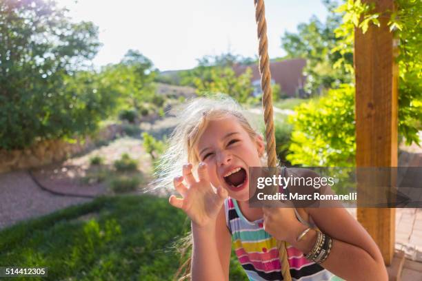 caucasian girl playing on rope swing - snarling stock pictures, royalty-free photos & images