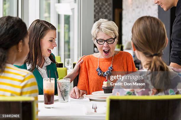 women celebrating birthday in restaurant - older woman birthday stock pictures, royalty-free photos & images