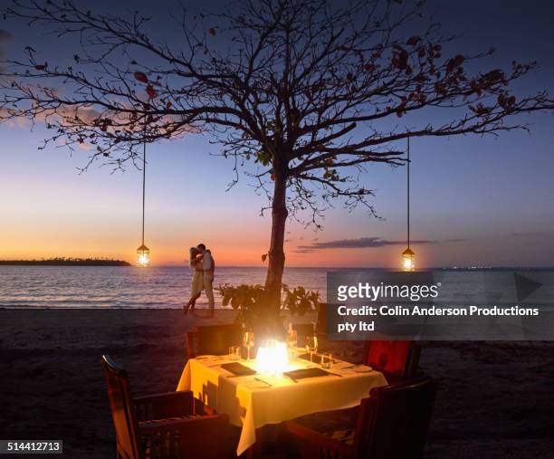 caucasian couple relaxing at beach restaurant - evening meal restaurant stock pictures, royalty-free photos & images