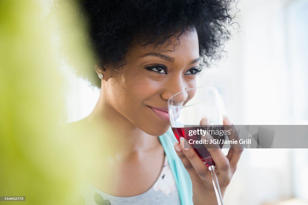 African American woman drinking glass of wine