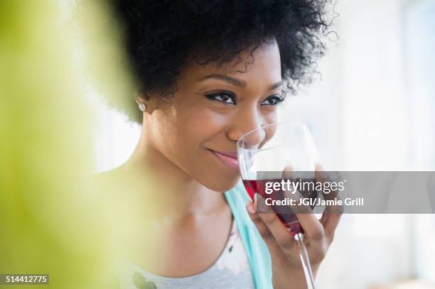 african american woman drinking glass of wine - pampering stock pictures, royalty-free photos & images