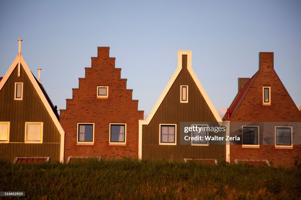 Houses with triangular roofs built side by side