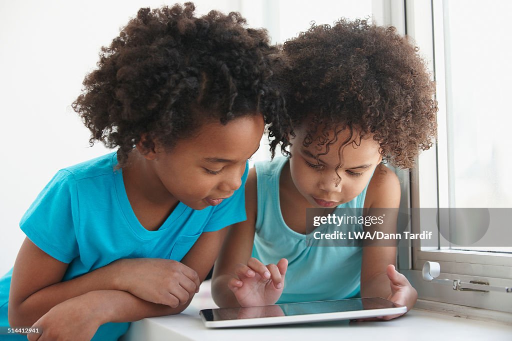 Black girls using tablet computer