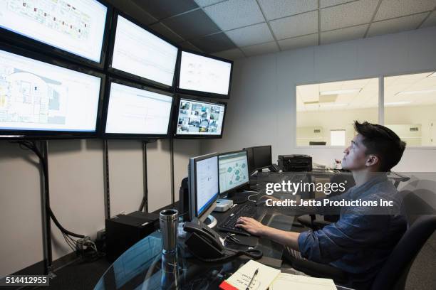 chinese businessman working in control room - good technology inc stock pictures, royalty-free photos & images