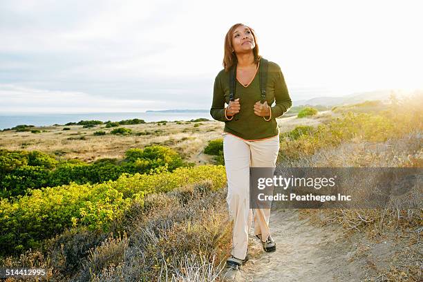 black woman standing on rural hillside - african american hiking stock pictures, royalty-free photos & images