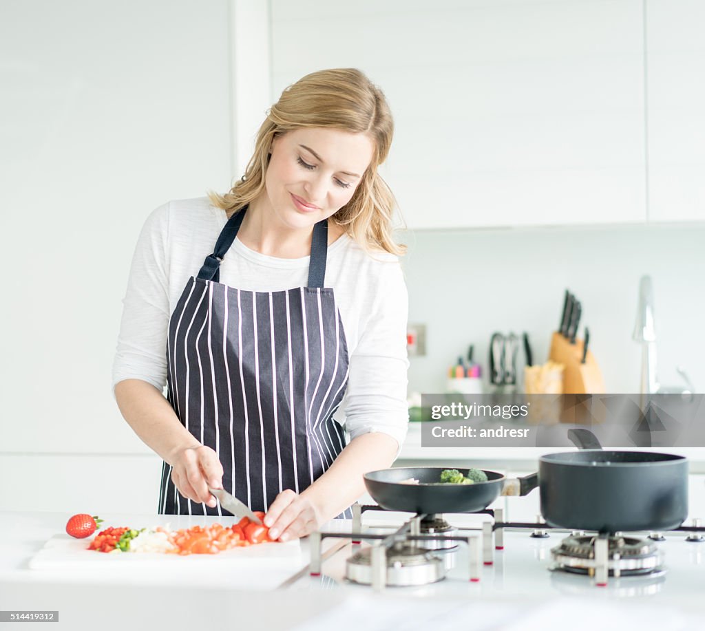 Woman cooking dinner at home
