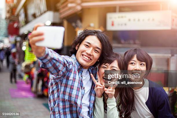 group of young japanese people making selfie, tokyo, - self portrait photography stock pictures, royalty-free photos & images