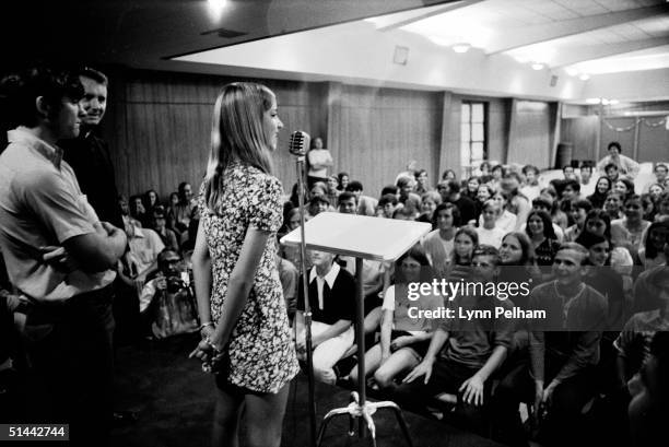 American tennis player Chris Evert speaks into a microphone before an assembly of fellow students at St. Thomas Aquinas High School after her return...