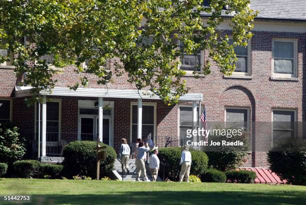 Women walk on the grounds near a building at the Alderson Federal Prison Camp where Martha Stewart turned herself in October 8, 2004 in Alderson,...