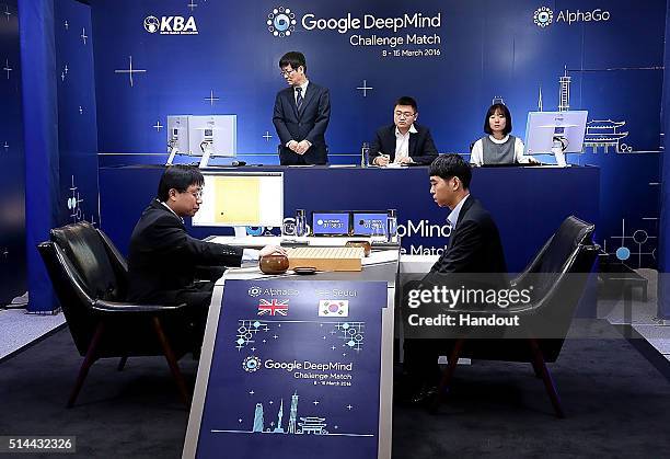 In this handout image provided by Google, South Korean professional Go player Lee Se-Dol waits after putting the first stone against Google's...