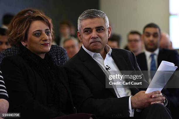 Labour's London mayoral candidate Sadiq Khan sits with his wife Saadiya as he waits to launch his manifesto at Canary Wharf on March 9, 2016 in...