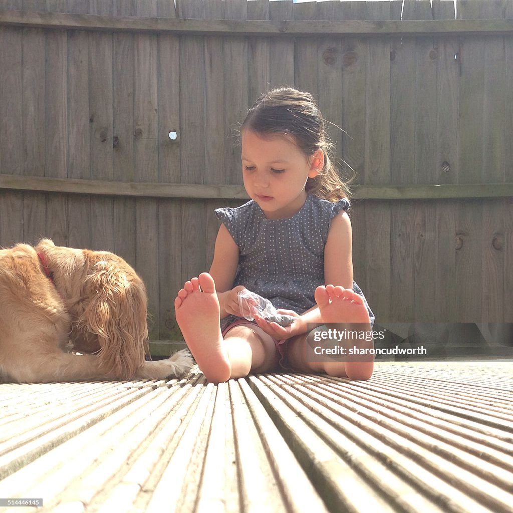 Girl sitting on patio terrace with her dog