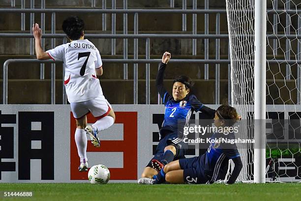 Yukari Kinga and Azusa Iwashimizu of Japan block the shot by Kim Su Gyong of North Korea during the AFC Women's Olympic Final Qualification Round...