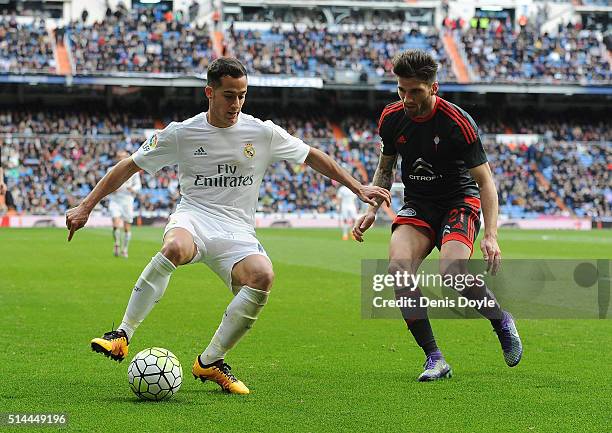 Lucas Vazquez of Real Madrid is challenged by Carles Planas of Celta Vigo during the La Liga match between Real Madrid CF and Celta Vigo at Estadio...