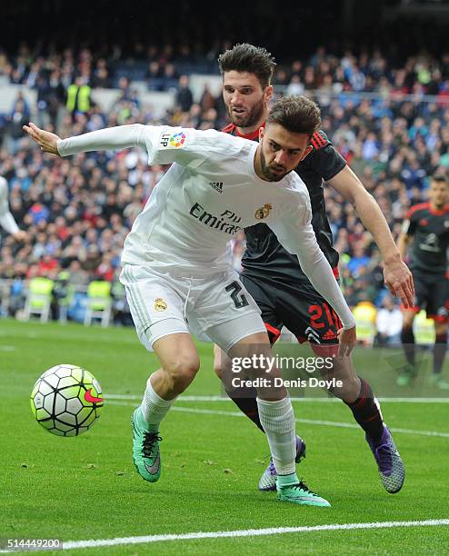 Borja Mayoral of Real Madrid tries to hold on to the ball while being challenged by Carles Planas of Celta Vigo during the La Liga match between Real...