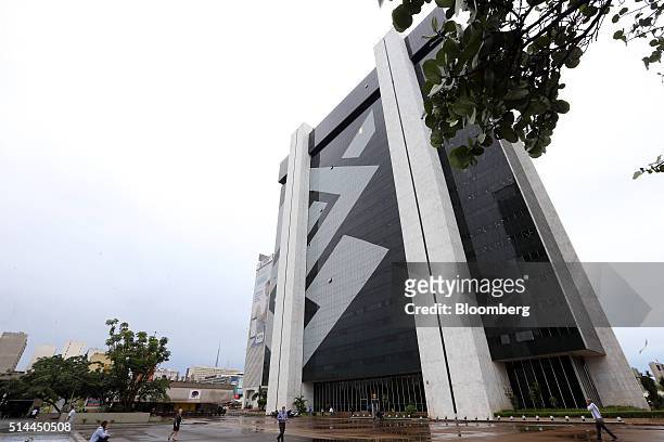 People walk outside the headquarters of the Bank of Brazil in Brasilia, Brazil, on Monday, March 7, 2016. Brazils currency, the real, has...