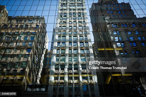 New York, United States of America Houses are reflected in the glass facade of a skyscraper in Manhattan. On February 27, 2016 in New York, United...