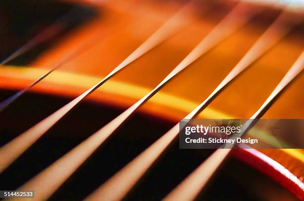 macro closeup of vibrating guitar strings - musical instrument string stock pictures, royalty-free photos & images