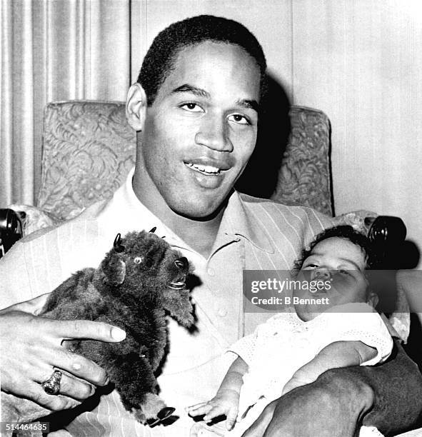 Simpson, who was selected as the number 1 overall draft pick by the Buffalo Bills, holds his two-month old daughter Arnelle on January 28, 1969 in...