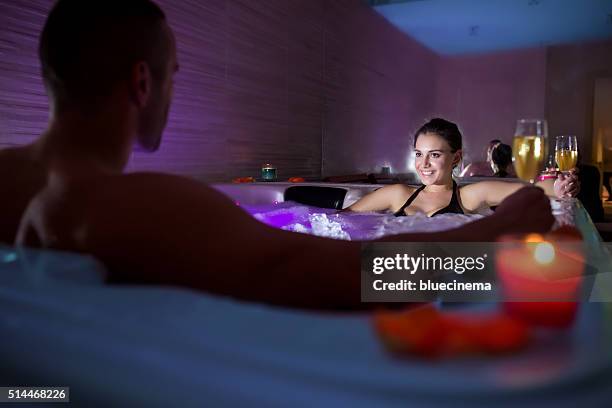 toasting in hot tub - bath relaxation stock pictures, royalty-free photos & images