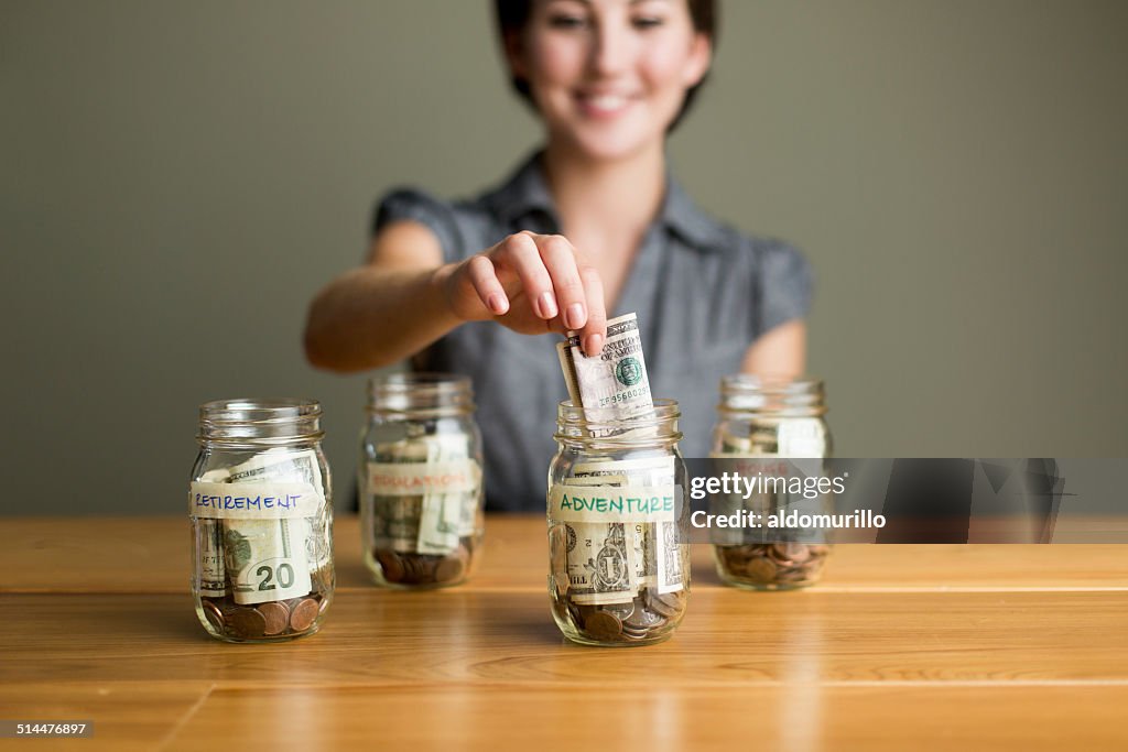 Woman saving in jars