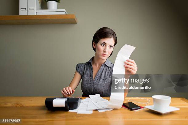 young accountant working - adding machine tape stock pictures, royalty-free photos & images