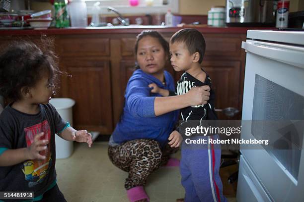 In the kitchen, Dipson Gurung argues with his cousin, Sajal, as the latter's mother, Tika holds him, Burlington, Vermont, January 5, 2016. Members of...