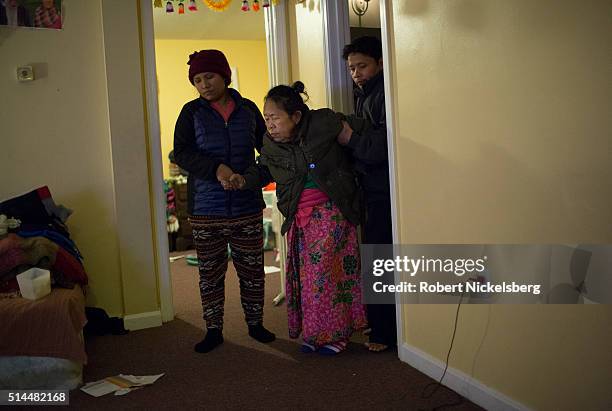 Married couple Hema and Dil Gurung help Dil's mother, Man Maya Gurung, as they enter their apartment, Burlington, Vermont, February 1, 2016. Members...
