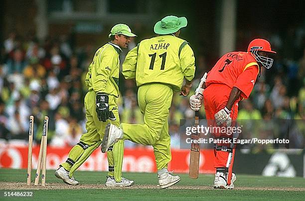 Henry Olonga of Zimbabwe is stumped by Moin Khan of Pakistan off the bowling of Saqlain Mushtaq the first wicket of a hat-trick - during the ICC...