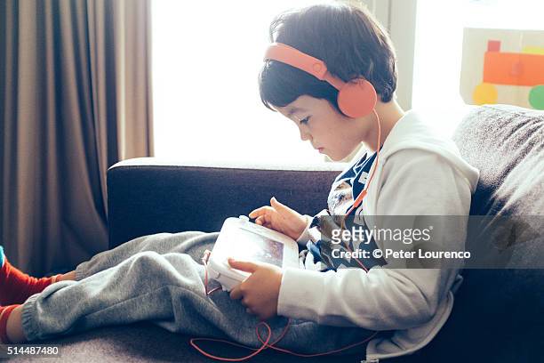 young boy playing a computer game - playstation stock pictures, royalty-free photos & images