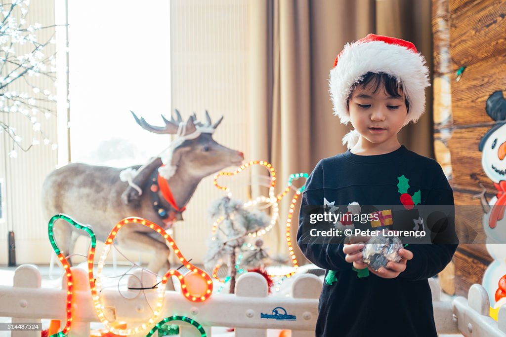 Young boy holding a Christmas gift