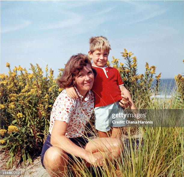 a mother and son are together on the beach. - boys photos stock-fotos und bilder