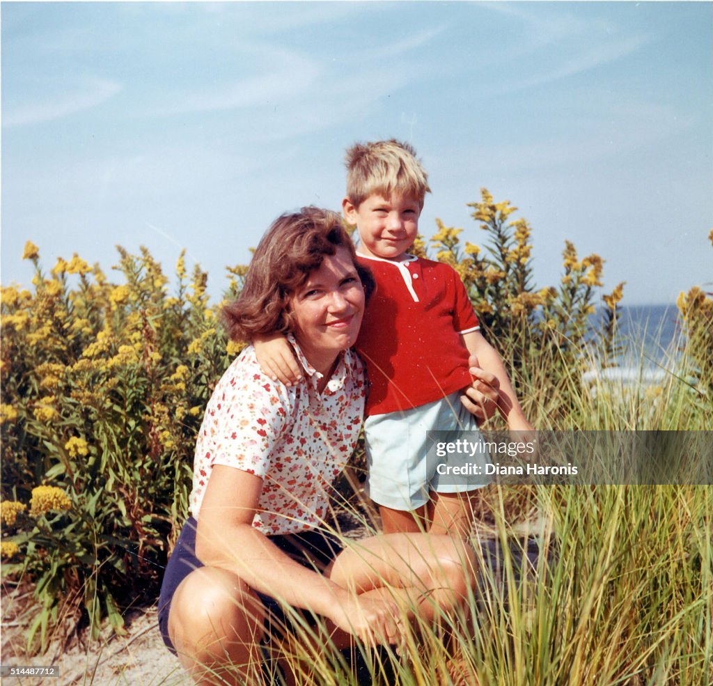 A mother and son are together on the beach.