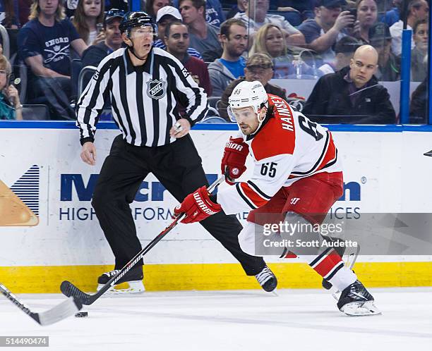 Ron Hainsey of the Carolina Hurricanes skates against the Tampa Bay Lightning in front of linesman Pierre Racicot at the Amalie Arena on March 5,...