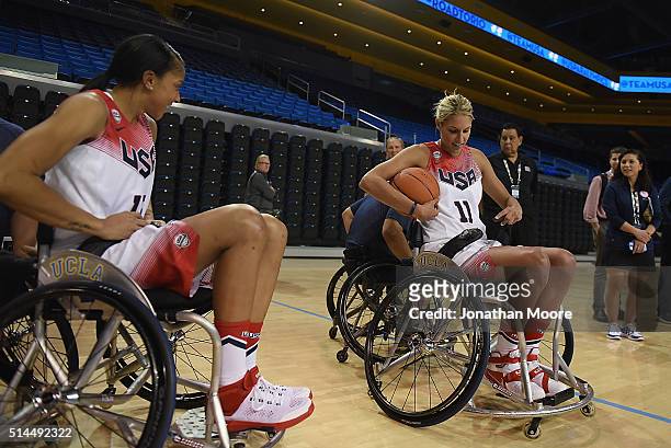 Candice Parker and Elena Della Donne participate in a wheelchair basketball demonstration during the 2016 Team USA Media Summit at UCLA's Pauley...