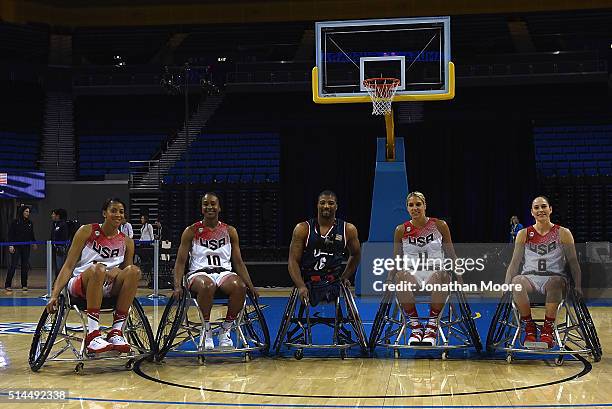 Candice Parker, Tamika Catchings, Trevon Jenifer, Elena Della Donna and Sue Bird pose for a photo after a wheelchair basketball demonstration during...