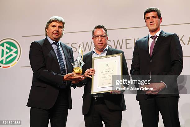 Markus Kauczinski of Karlsruher SC receives the 'Coach of the Year' award from DFB Vice President Ronny Zimmermann and Karlsruhe manager Jens Todt...