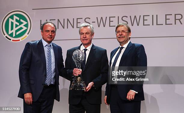 Ottmar Hitzfeld poses with Hansi Mueller and DFB Vice President Rainer Koch after receiving the lifetime achievement award during the Coaching Award...