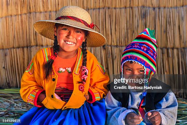 happy peruvian children on uros island - uroseilanden stockfoto's en -beelden