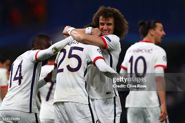 Adrien Rabiot of PSG is congratulated by teammate David Luiz of PSG after scoring the opening goal during the UEFA Champions League round of 16,...