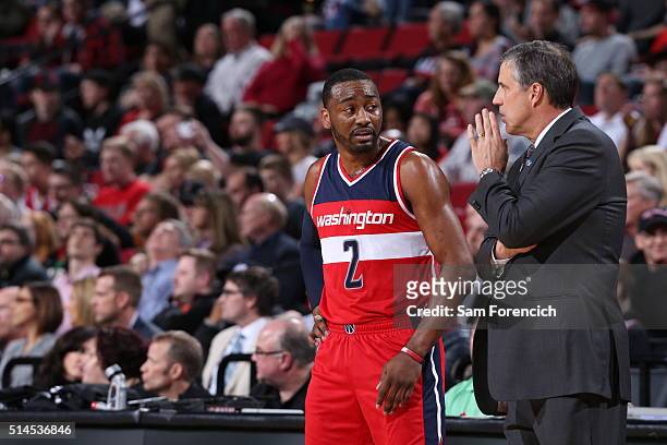 John Wall and Randy Wittman of the Washington Wizards talk during the game against the Portland Trail Blazers on March 8, 2016 at the Moda Center...